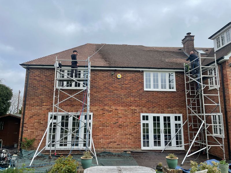 Roof cleaning carried out safely from scaffold towers by The Roof Moss Cleaners in Horsham